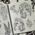 Inside pages of Volume 3 sketchbook by Javier DeLuna featuring line drawings of various subjects, including angel and devil lady heads, flowers, and a strawberry vine.