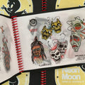 Inside pages of Neon Moon Vol. 2 featuring traditional color flash of masks, including a few versions of 'Smile Now Cry Later, and a shrunken head.