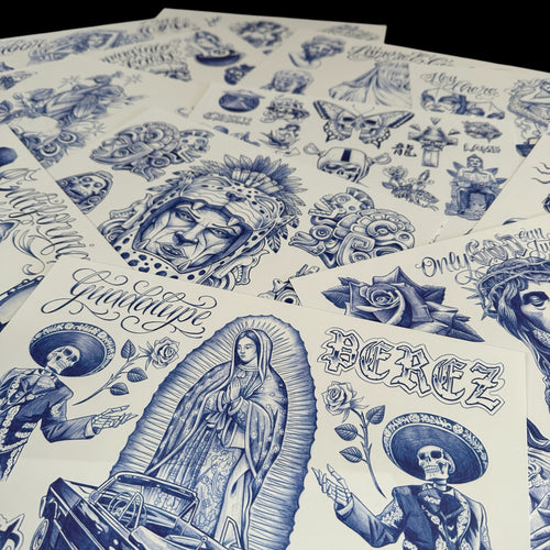 Photograph of flash sheets showcasing tattoo art in the Chicano and black and grey style. Motifs include the Virgin Mary, skulls, pre-Hispanic imagery, ladies, roses, and much more.