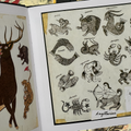 Inside pages of of Rosie Folk Art Tattoo Flash book featuring traditional flash sheets showcasing animals and the zodiac signs.