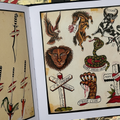 Inside pages of of Rosie Folk Art Tattoo Flash book featuring traditional flash sheets in color showcasing spears, animals, and crosses.