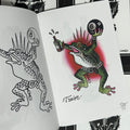 Inside pages of Subculture Frogs featuring a color illustration of a punk frog with a spiky mohawk, holding an 8-ball and a beer.