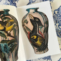 Inside pages of Tattoo X Ceramics featuring a colorful birds painted on a vase by Bryan Burk.