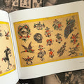 Inside pages of The Bert Grimm Tattoo Museum Collection featuring color flash by Gene Grimm showcasing traditional motifs such as skulls, daggers, hearts, and animals.