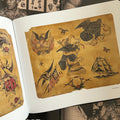 Inside pages of The Bert Grimm Tattoo Museum Collection featuring vintage color flash by Darnell Potter showcasing eagles and a ship.