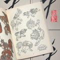 Inside pages of Japanese Paintings & Drawings featuring line drawings of foo dogs. Color study can be found on the opposite page.