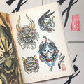 Inside pages of Japanese Paintings & Drawings featuring color paintings of two hannya masks and two dragon heads. A large hannya mask painting takes over the opposing page.