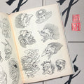 Inside pages of Japanese Paintings & Drawings featuring line drawings of yokai heads.