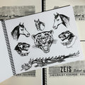Inside pages of Dana Brunson - Zeis School of Tattooing Vol. 2 featuring animal heads of horses, panthers, and a tiger. At the bottom, is a full dragon. All done in the traditional style.