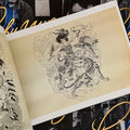 Inside pages Tattoo Master Pinky Yun: The Don Ed Hardy Collection featuring an intricate line drawing of a warrior lady surrounded by three tigers.