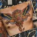 Inside pages Tattoo Master Pinky Yun: The Don Ed Hardy Collection featuring a finished chest piece of a winged lion in color.