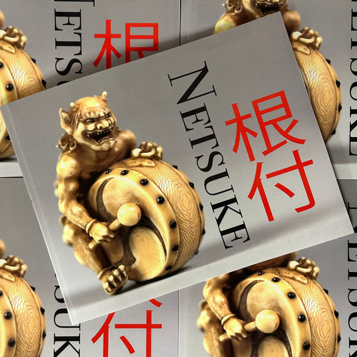 Front cover of Netsuke featuring a sculpture of a demon playing a drum.