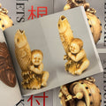 Inside pages of Netsuke featuring a traditional Japanese small sculpture of a child holding a fish, seen from two different angles.