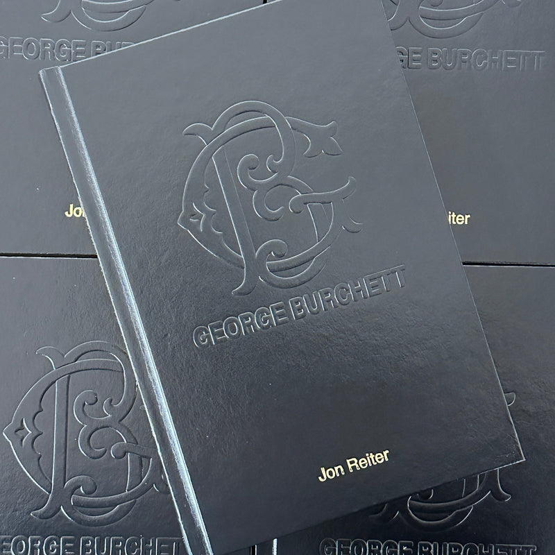 Front cover of Essential Works From the Studio of George Burchett featuring an embossed logo and title on a black background.