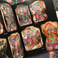 Inside pages of Aaron Bell - Slave to the Needle featuring full color photos of large back pieces.