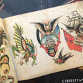 Old school imagery like ships, eagles, and dragons, from the Christian Warlich Tattoo Flash Book. 