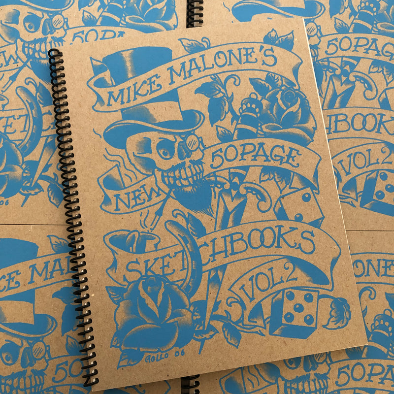 Front cover of Sketchbook Vol. 2 by Mike Malone featuring blue art and lettering on a cardboard cover. 