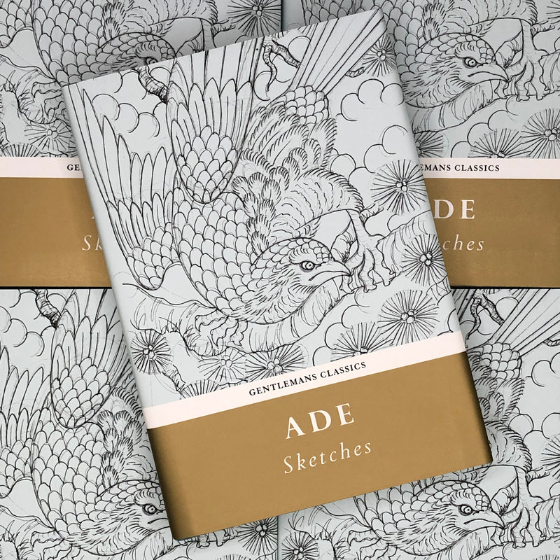 Front cover of Ade Sketches book featuring a line drawing of a bird on a light blue cover with gold banner