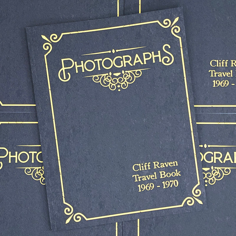 Cliff Raven Travel Book front cover. Black book with gold writing. 