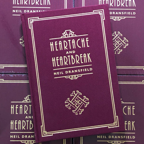 Front cover of Neil Dransfield - Heartache and Heartbreak featuring fold lettering on a burgundy hard cover book.