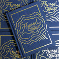Front cover of Chad Koeplinger - Animal Songs featuring embossed gold lettering on a dark blue hardbound cover.