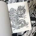 Inside pages of Filip Leu - Dragons: The Collection featuring a black outline illustration of a dragon on a white background.