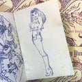 Inside pages of Pinky Yun - Lost Designs featuring a dark blue outline of a cowgirl pinup on a light yellow background.