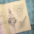 Inside pages of Jesse Strother - Lines featuring traditional line drawings of a spiderweb and daggers.