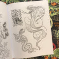 Inside pages of Henning - Vol.1 displaying 3 snakes. One snake is coming out of water. One snake is a large cobra, and the last snake is curled around a knife.