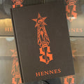 Belzel Books presents Hennes Sketches. Orange illustration on black cover.